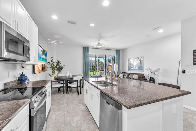 7124 Summer Holly Pl, Riverview, FL 33578 - kitchen with appliances with stainless steel finishes, a ceiling fan, a center island with sink, white cabinetry, and recessed lighting