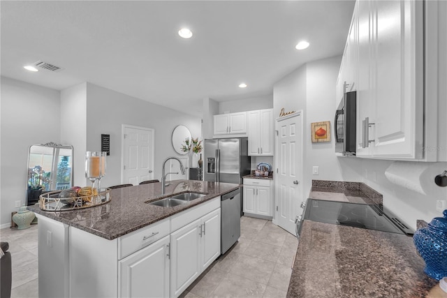 7124 Summer Holly Pl, Riverview, FL 33578 - kitchen featuring stainless steel appliances, white cabinets, a center island with sink, light tile patterned floors, and recessed lighting