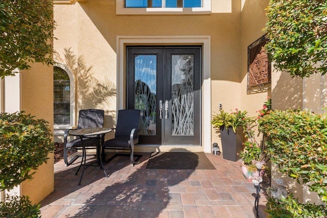 8358 Dunham Station Dr, Tampa, FL 33647 - entrance to property with french doors, stucco siding, and a patio