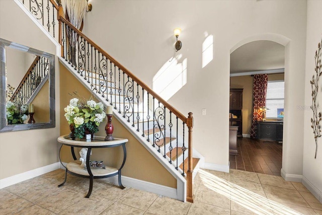 8358 Dunham Station Dr, Tampa, FL 33647 - stairway with arched walkways and tile patterned flooring