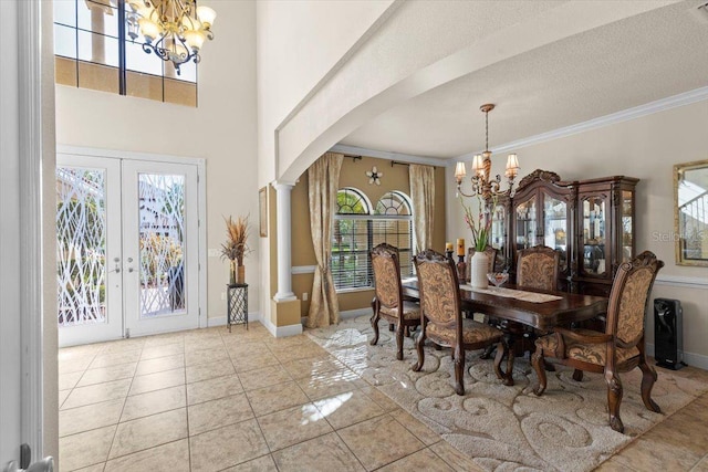 8358 Dunham Station Dr, Tampa, FL 33647 - dining area with a chandelier, arched walkways, french doors, crown molding, and tile patterned floors