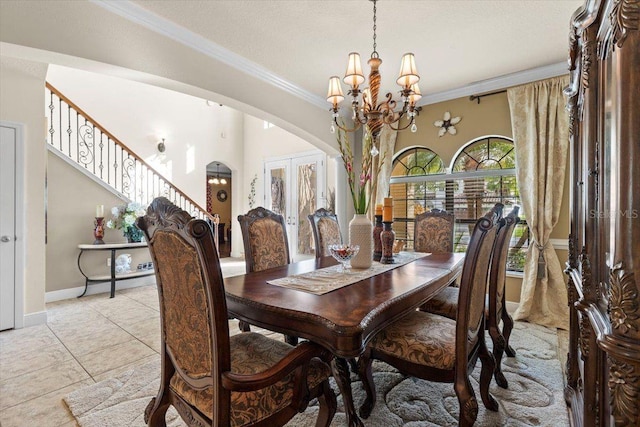 8358 Dunham Station Dr, Tampa, FL 33647 - dining room featuring arched walkways, a chandelier, stairway, crown molding, and light tile patterned floors