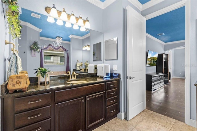 8358 Dunham Station Dr, Tampa, FL 33647 - bathroom featuring crown molding, vanity, and tile patterned floors