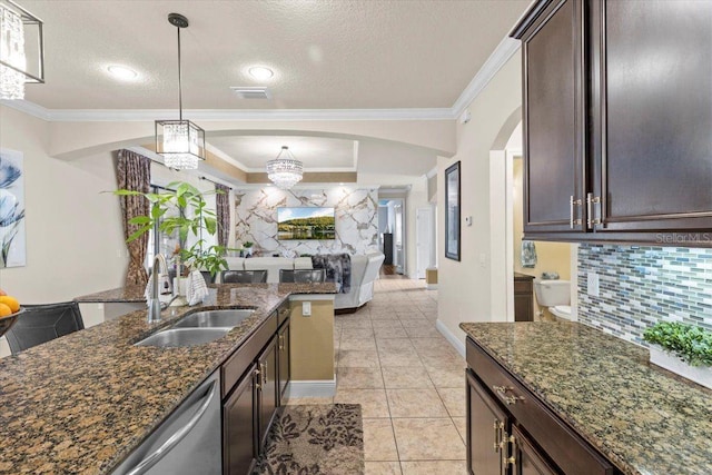 8358 Dunham Station Dr, Tampa, FL 33647 - kitchen with arched walkways, decorative backsplash, a chandelier, dark brown cabinets, and a textured ceiling