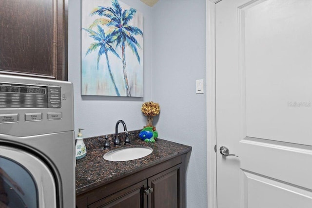 8358 Dunham Station Dr, Tampa, FL 33647 - bathroom featuring washer / clothes dryer and vanity