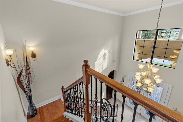 8358 Dunham Station Dr, Tampa, FL 33647 - staircase with a chandelier, crown molding, and wood finished floors