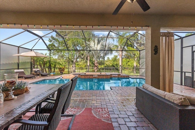 8358 Dunham Station Dr, Tampa, FL 33647 - view of swimming pool featuring a patio area, a ceiling fan, glass enclosure, and a pool with connected hot tub