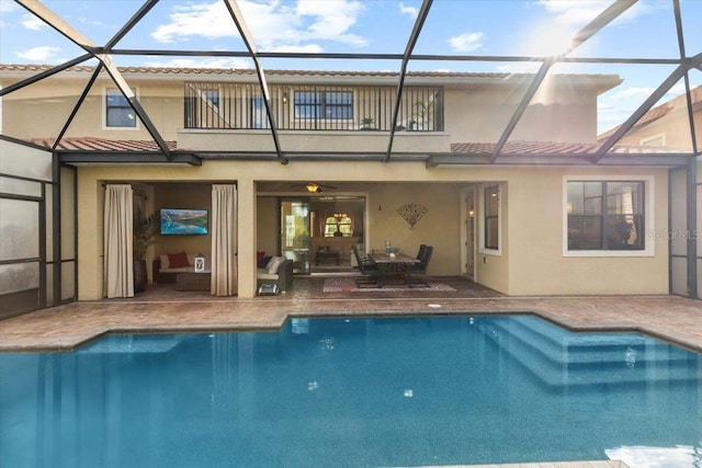 8358 Dunham Station Dr, Tampa, FL 33647 - back of house featuring stucco siding, a balcony, a patio, and an outdoor pool