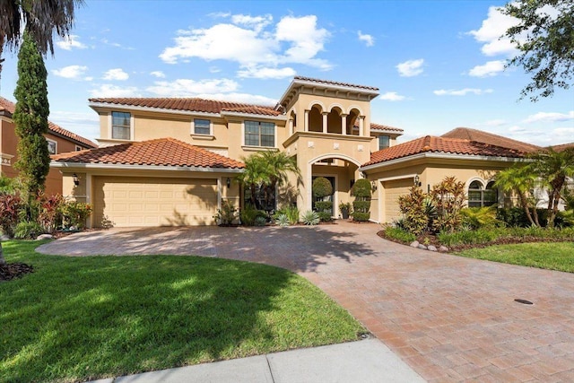 8358 Dunham Station Dr, Tampa, FL 33647 - mediterranean / spanish house with stucco siding, an attached garage, a front lawn, and a tile roof