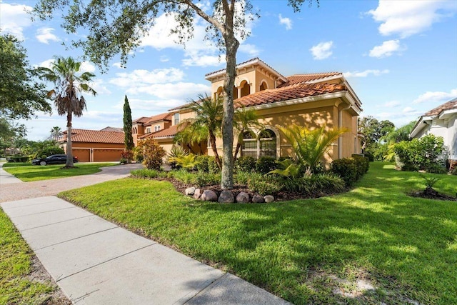 8358 Dunham Station Dr, Tampa, FL 33647 - mediterranean / spanish home featuring a tiled roof, a front lawn, and stucco siding