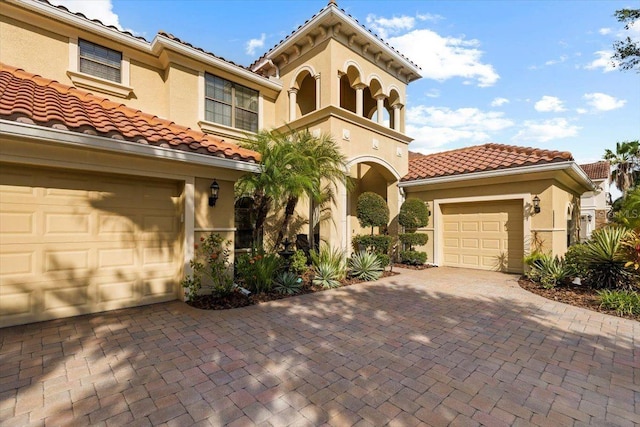 8358 Dunham Station Dr, Tampa, FL 33647 - view of front of property featuring decorative driveway, stucco siding, a tile roof, and a balcony