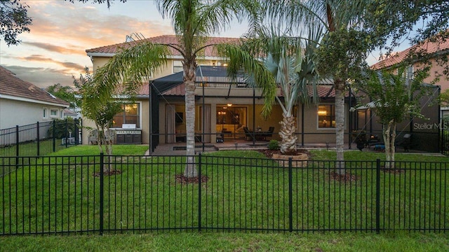 8358 Dunham Station Dr, Tampa, FL 33647 - back of property at dusk with stucco siding and a patio area