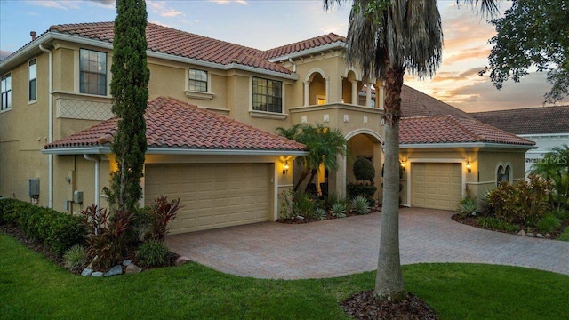 8358 Dunham Station Dr, Tampa, FL 33647 - mediterranean / spanish house with a tiled roof, a garage, stucco siding, and decorative driveway