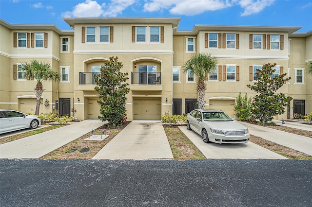 5521 Yellowfin Ct, New Port Richey, FL 34652 - multi unit property featuring stucco siding, an attached garage, and driveway