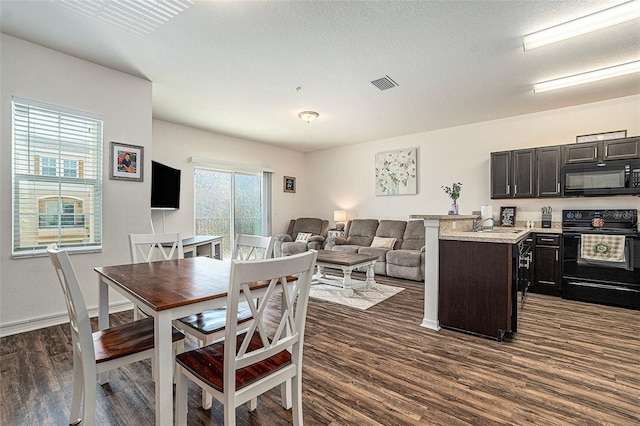 5521 Yellowfin Ct, New Port Richey, FL 34652 - dining area with dark wood finished floors and baseboards