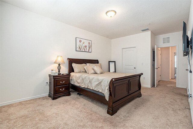 5521 Yellowfin Ct, New Port Richey, FL 34652 - bedroom with light carpet and a textured ceiling