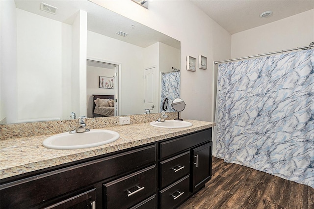 5521 Yellowfin Ct, New Port Richey, FL 34652 - ensuite bathroom featuring wood finished floors, double vanity, and a shower with shower curtain