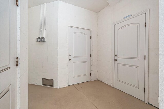 5521 Yellowfin Ct, New Port Richey, FL 34652 - foyer entrance featuring concrete flooring and concrete block wall