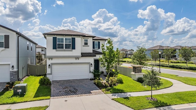 7517 Notched Pine Bnd, Wesley Chapel, FL 33545 - traditional-style home with stucco siding, decorative driveway, a garage, and a residential view