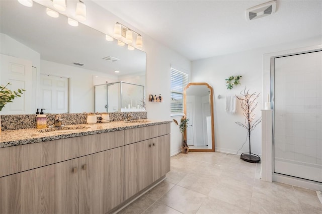 7517 Notched Pine Bnd, Wesley Chapel, FL 33545 - bathroom featuring double vanity, a stall shower, and tile patterned flooring