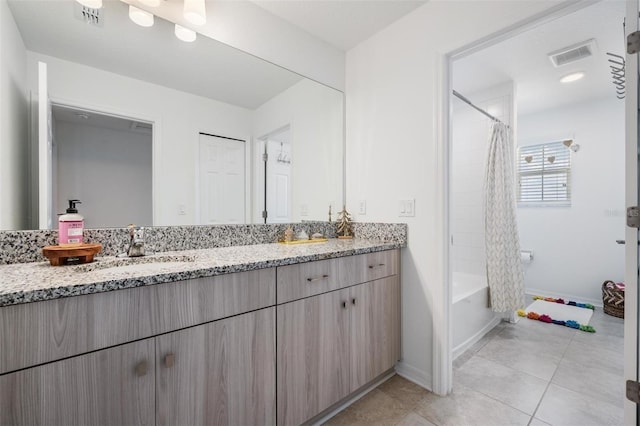 7517 Notched Pine Bnd, Wesley Chapel, FL 33545 - full bath with double vanity, tile patterned floors, and shower / tub combo