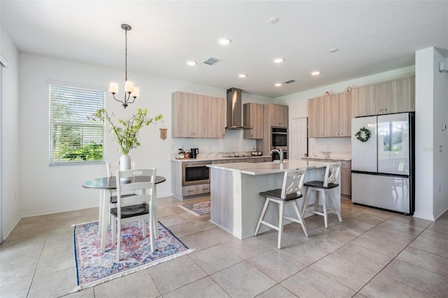 7517 Notched Pine Bnd, Wesley Chapel, FL 33545 - kitchen with appliances with stainless steel finishes, wall chimney range hood, a kitchen breakfast bar, modern cabinets, and light brown cabinetry