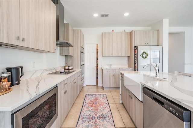 7517 Notched Pine Bnd, Wesley Chapel, FL 33545 - kitchen featuring stainless steel appliances, wall chimney range hood, light brown cabinets, and recessed lighting