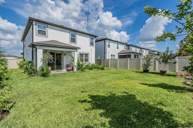 7517 Notched Pine Bnd, Wesley Chapel, FL 33545 - back of property with stucco siding, a fenced backyard, and a residential view