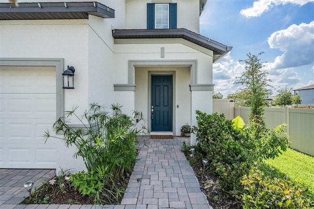 7517 Notched Pine Bnd, Wesley Chapel, FL 33545 - view of exterior entry featuring stucco siding and a garage