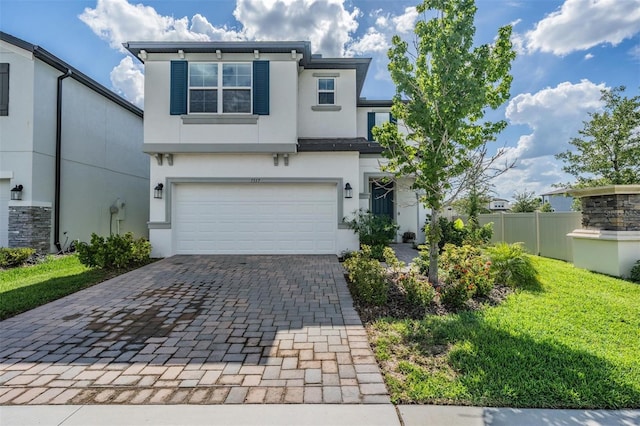 7517 Notched Pine Bnd, Wesley Chapel, FL 33545 - view of front of house featuring stucco siding, decorative driveway, and a garage