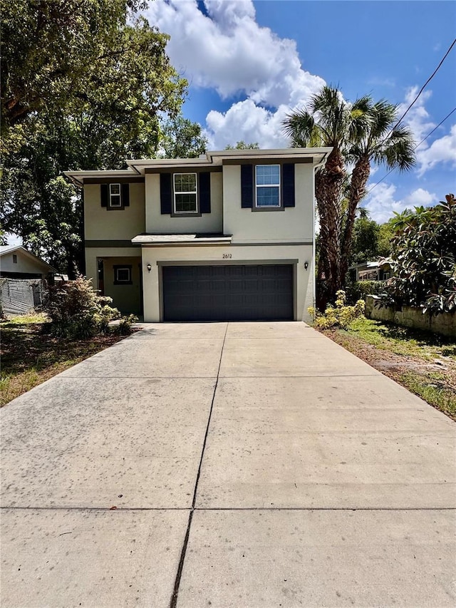2612 E 26th Ave, Tampa, FL 33605 - traditional home with stucco siding, an attached garage, and driveway
