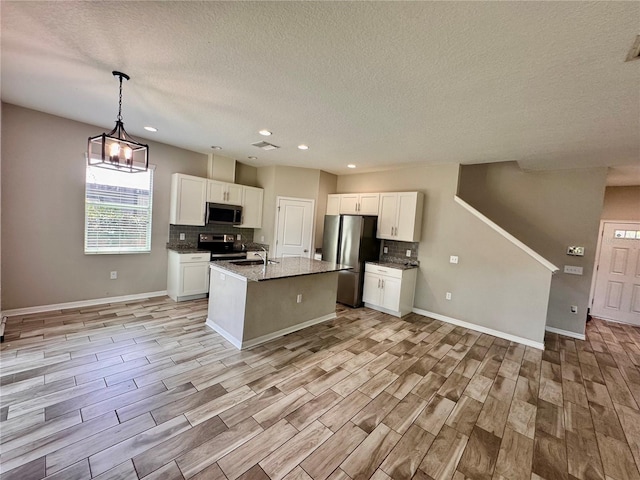 2612 E 26th Ave, Tampa, FL 33605 - kitchen featuring stainless steel appliances, a textured ceiling, decorative backsplash, white cabinets, and recessed lighting