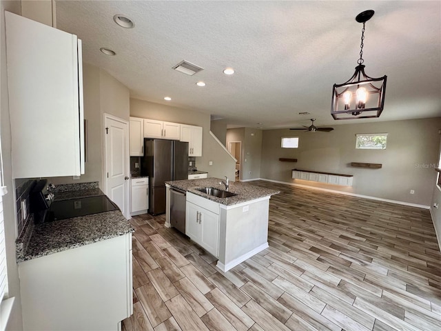 2612 E 26th Ave, Tampa, FL 33605 - kitchen featuring appliances with stainless steel finishes, a ceiling fan, white cabinets, light wood-style floors, and recessed lighting