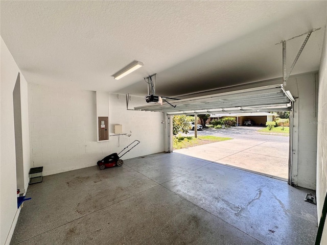 2612 E 26th Ave, Tampa, FL 33605 - garage with a garage door opener, electric panel, and concrete block wall