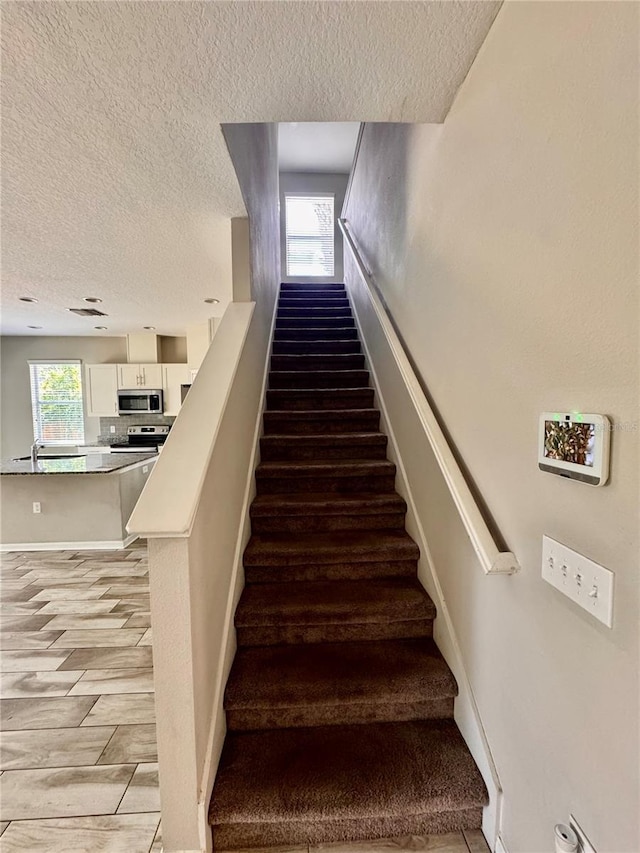 2612 E 26th Ave, Tampa, FL 33605 - stairway with a textured ceiling
