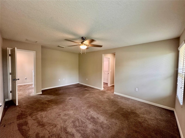 2612 E 26th Ave, Tampa, FL 33605 - empty room featuring ceiling fan, dark colored carpet, and a textured ceiling