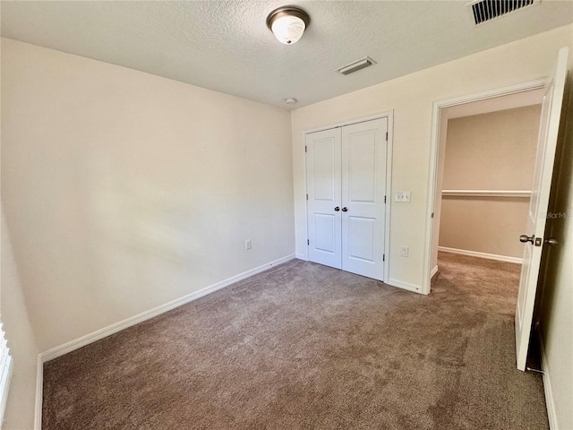 2612 E 26th Ave, Tampa, FL 33605 - unfurnished bedroom with carpet, a textured ceiling, and a closet