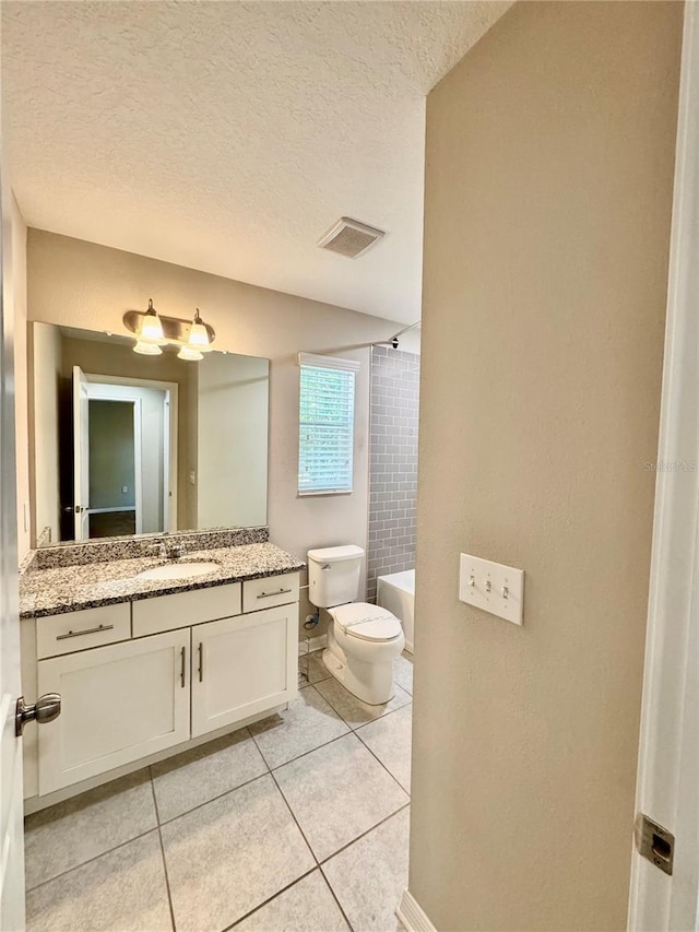 2612 E 26th Ave, Tampa, FL 33605 - full bath featuring vanity, tile patterned flooring, a textured ceiling, and bathing tub / shower combination