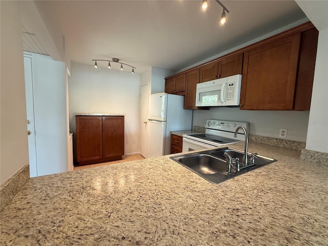 12300 Vonn Rd Unit 9105, Largo, FL 33774 - kitchen with white appliances, rail lighting, and light countertops