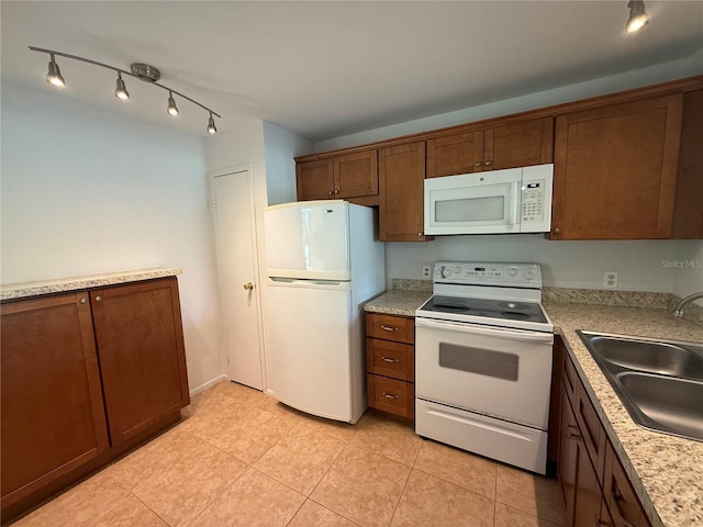 12300 Vonn Rd Unit 9105, Largo, FL 33774 - kitchen with white appliances, light tile patterned floors, light countertops, and rail lighting