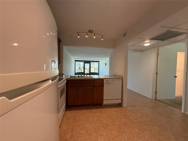 12300 Vonn Rd Unit 9105, Largo, FL 33774 - kitchen with white appliances, light tile patterned floors, and brown cabinetry