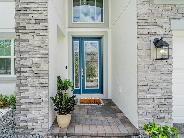7700 Bronze Oak Dr, Wesley Chapel, FL 33545 - doorway to property featuring stucco siding and stone siding