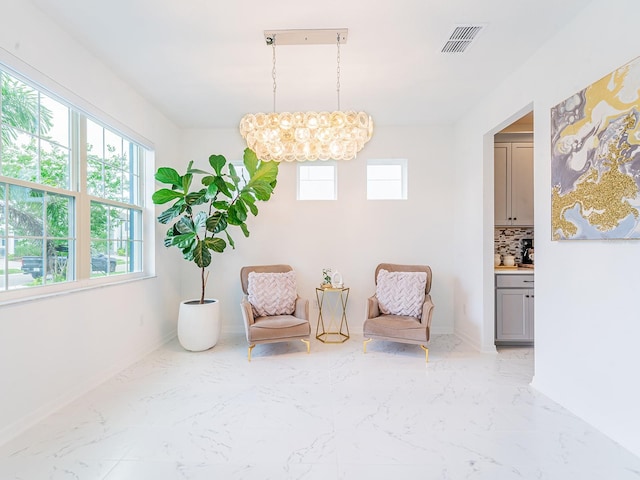 7700 Bronze Oak Dr, Wesley Chapel, FL 33545 - sitting room with healthy amount of natural light, a chandelier, and light marble finish flooring