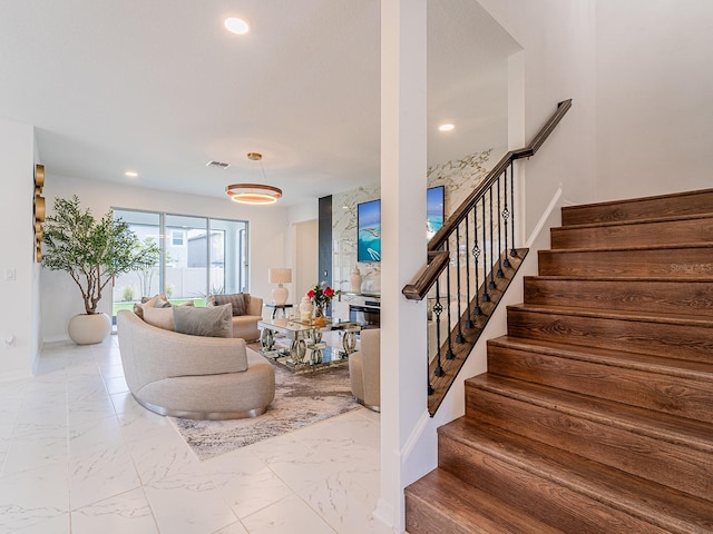 7700 Bronze Oak Dr, Wesley Chapel, FL 33545 - stairway featuring marble look tiles and recessed lighting