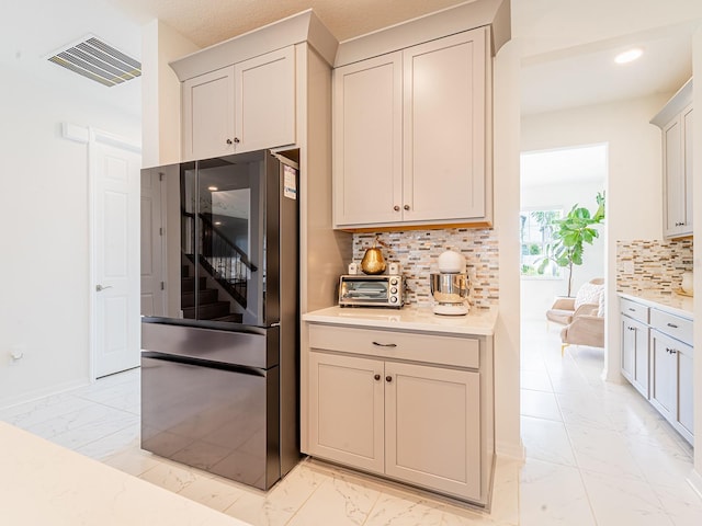 7700 Bronze Oak Dr, Wesley Chapel, FL 33545 - kitchen with smart refrigerator, light marble finish floors, light countertops, backsplash, and recessed lighting
