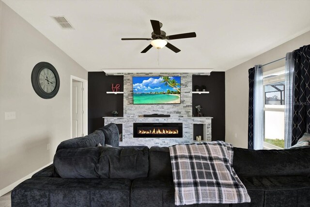 12838 Wildflower Meadow Dr, Riverview, FL 33579 - living room featuring ceiling fan and a glass covered fireplace