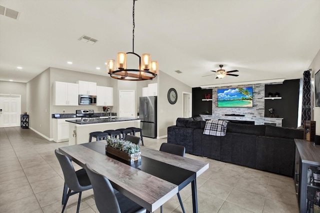 12838 Wildflower Meadow Dr, Riverview, FL 33579 - dining space with a chandelier, light tile patterned flooring, ceiling fan, recessed lighting, and vaulted ceiling