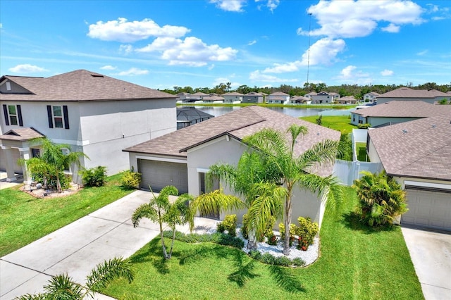 12838 Wildflower Meadow Dr, Riverview, FL 33579 - view of front of home with a residential view, stucco siding, concrete driveway, roof with shingles, and a water view