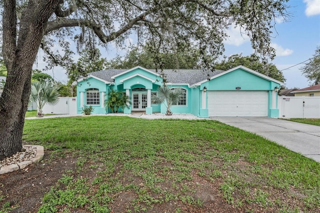 5283 Bevens Ave, Spring Hill, FL 34608 - ranch-style home with french doors, a gate, an attached garage, concrete driveway, and stucco siding