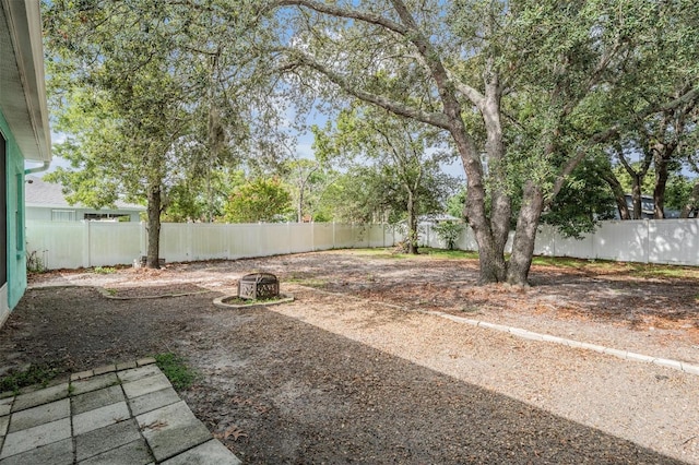 5283 Bevens Ave, Spring Hill, FL 34608 - fenced backyard featuring a fire pit